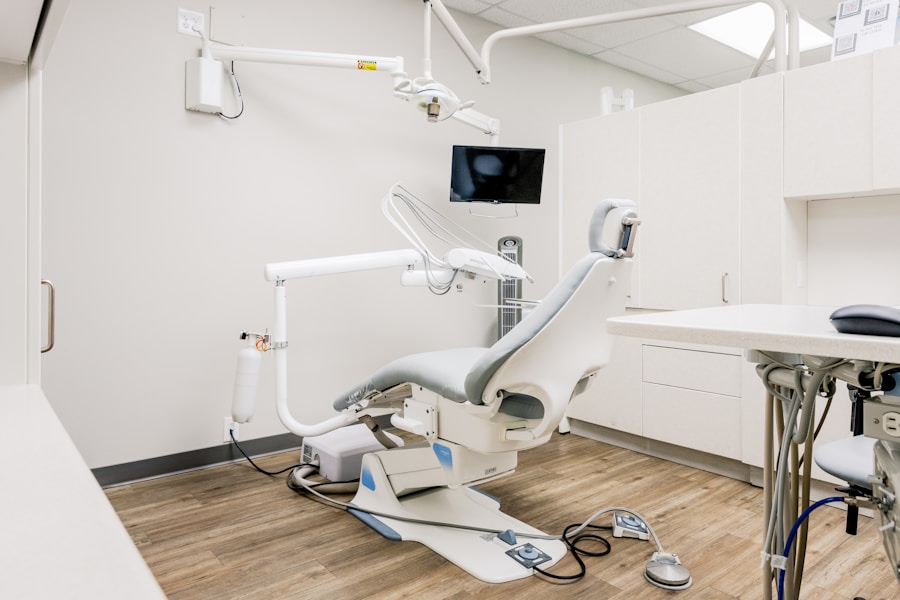 A modern dental treatment room with an ergonomic chair and equipment cabinet.