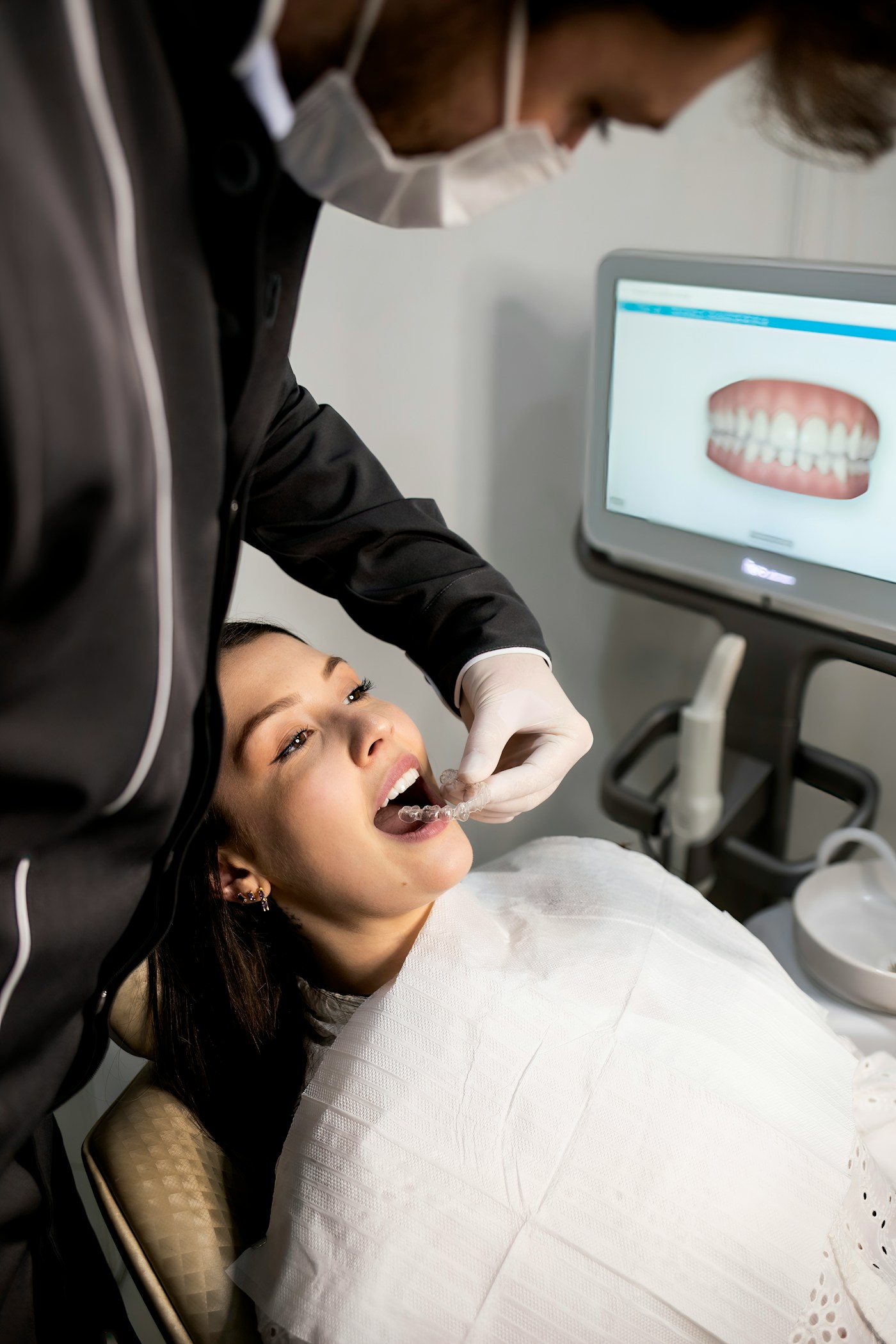 A dentist scanning a patient's teeth during a check-up at Adyar Dental Clinic.